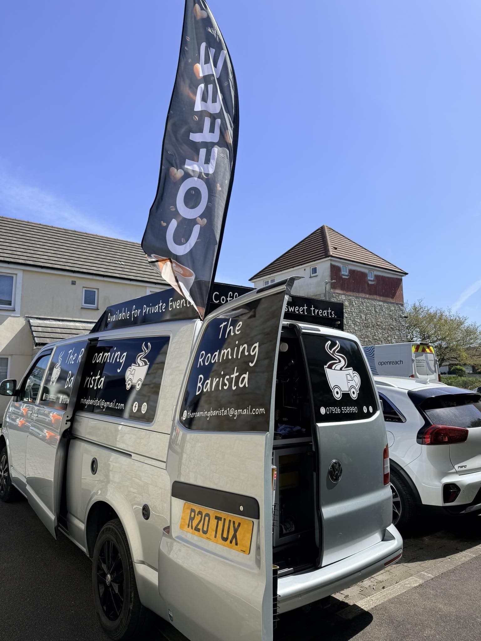 Rear of the Roaming Barista van with the COFFEE feather flag